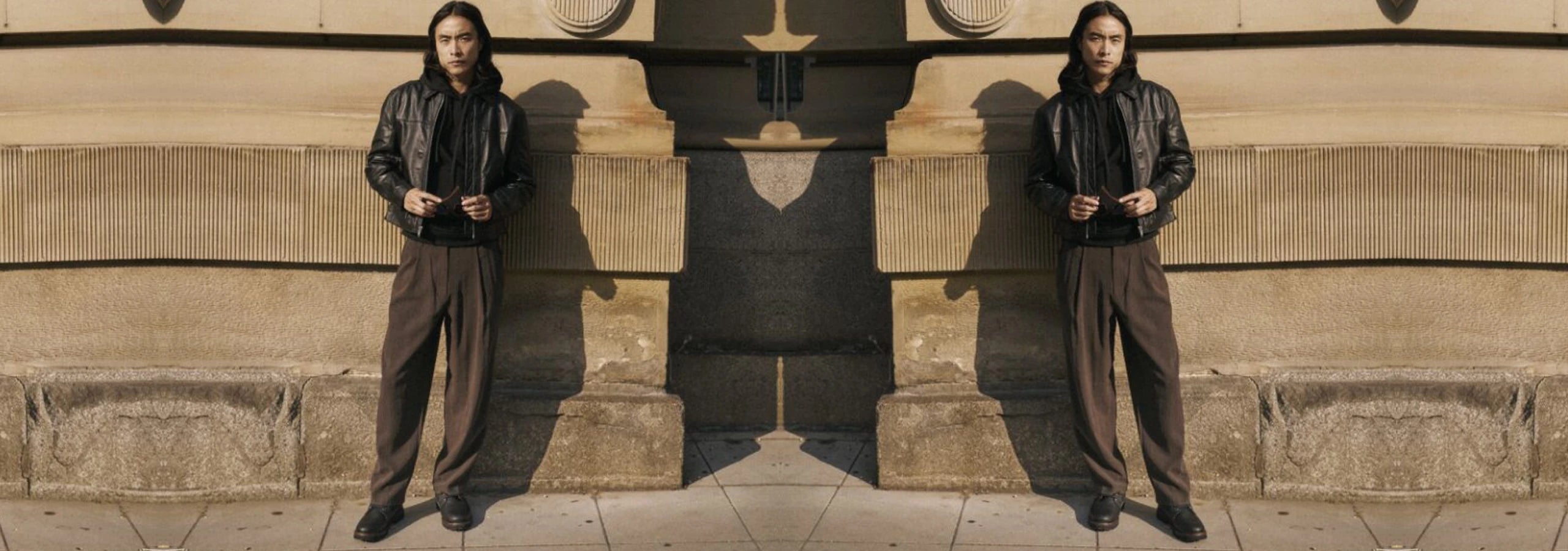 man standing by a wall wearing sioux boots