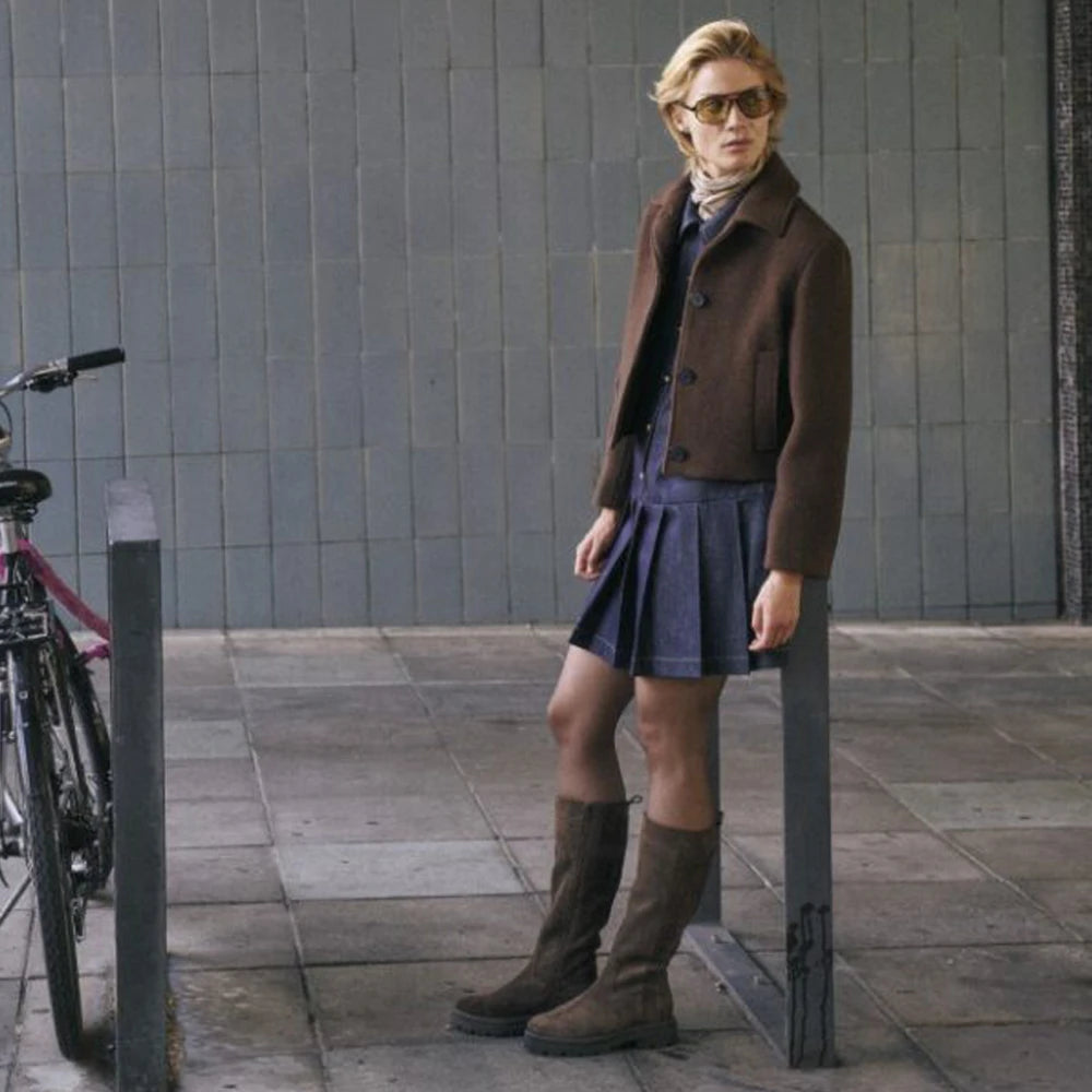 woman standing wearing sioux boots