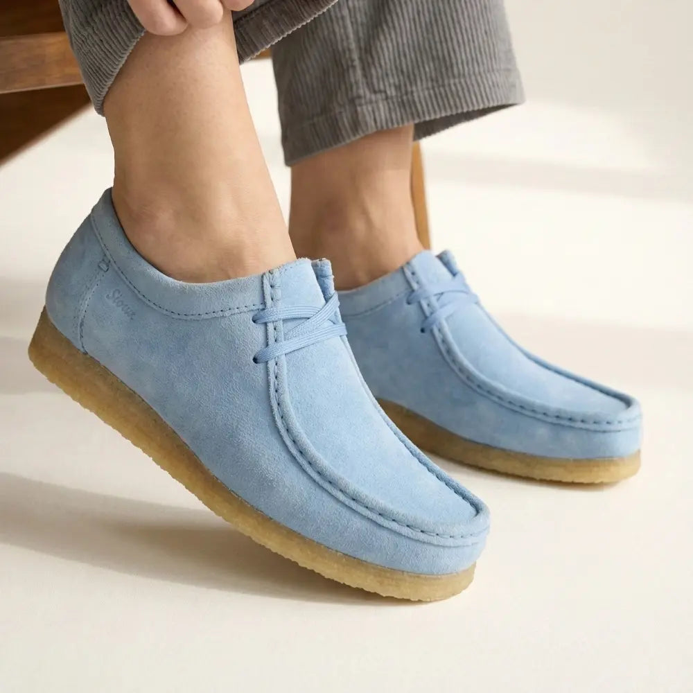 two feet with light blue mocasins by sioux